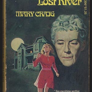 May include: A vintage paperback book titled Mistress of Lost River by Mary Craig. The cover features a dark green night scene with a large moon, a house, a running figure in a red dress, and a large, ghostly portrait of an older person.