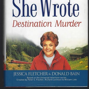 May include: Book cover for "Murder, She Wrote: Destination Murder." The title is in large blue letters, with the author's names and the series title at the bottom. The cover features a photo of a woman in a red jacket, with a mountain landscape and a train in the background.