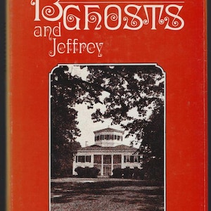 May include: A hardcover book with a bright orange cover featuring the title Mississippi 13 Ghosts and Jeffrey in black and white stylized lettering. A central rectangular frame displays a black and white illustration of a large house with trees.