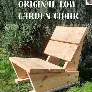 May include: A low, wooden garden chair with a slatted seat and backrest. The chair is made of light-colored wood and has a simple, modern design. The text "ORIGINAL LOW GARDEN CHAIR" is at the top. The text "All dimensions in the instructions are given in inches and millimeters" is at the bottom.