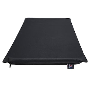 May include: A rectangular black cushion with a zipper closure along one edge. The cushion is made of a solid, dark fabric and has a tag attached to the corner. The cushion appears to be designed for comfort and support.