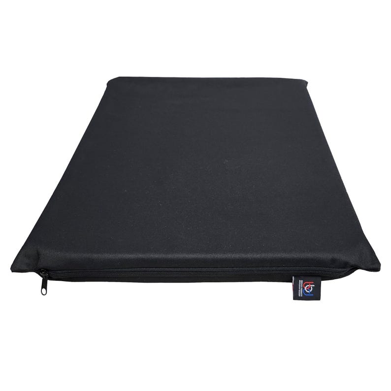 May include: A rectangular black cushion with a zipper closure along one edge. The cushion is made of a solid, dark fabric and has a tag attached to the corner. The cushion appears to be designed for comfort and support.