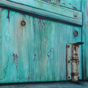 May include: A close-up of a weathered wooden door with peeling turquoise paint. A rusty metal latch is attached to the door.
