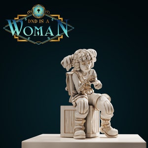 May include: A white painted figurine of a female character with short, curly hair, wearing a backpack and sitting on a white wooden crate. The figurine is holding a small object in her hands. The text "DND IS A WOMAN" is displayed above the figurine.