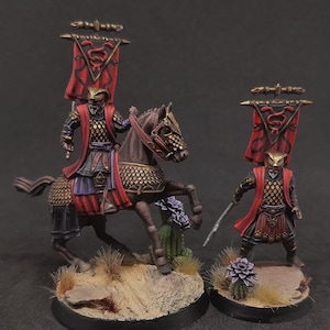 May include: Two painted miniature figures of warriors from the fantasy television series, "House of the Dragon". One figure is on horseback, holding a sword and a red banner with a dragon symbol. The other figure is standing, holding a sword and a red banner with a dragon symbol.