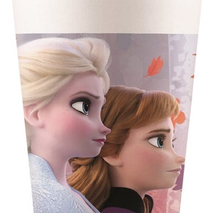 May include: A white paper cup with a design featuring Elsa and Anna from the movie Frozen. The cup has a purple, pink, and white background with a design of falling leaves.
