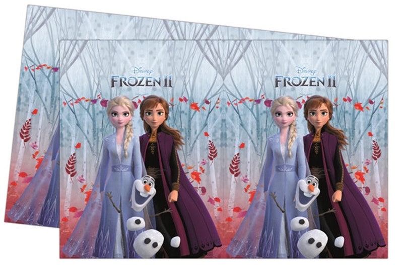 May include: Two Disney Frozen II characters, Elsa and Anna, stand in a snowy forest with Olaf the snowman. Elsa is wearing a light blue dress and Anna is wearing a dark purple dress. The text "Disney Frozen II" is at the top of the image.