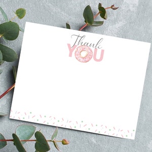 May include: A white thank you card with a pink doughnut and the words "Thank You" in pink letters. The card has a border of pink and green sprinkles.