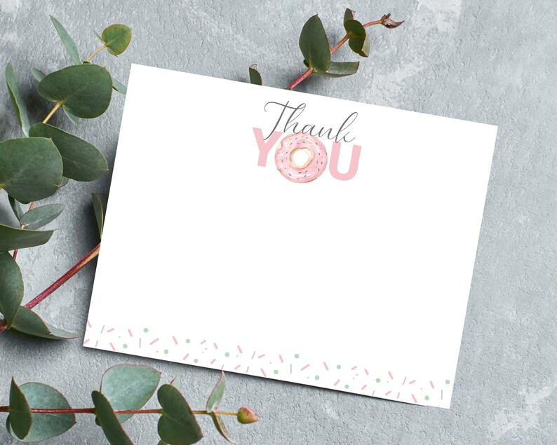 May include: A white thank you card with a pink doughnut and the words "Thank You" in pink letters. The card has a border of pink and green sprinkles.