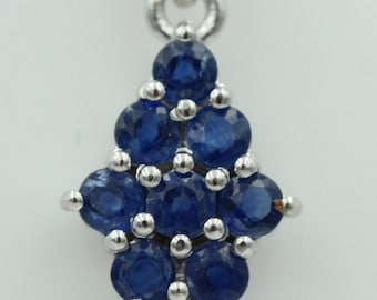 May include: A silver pendant necklace with a cluster of blue sapphires in a diamond shape.