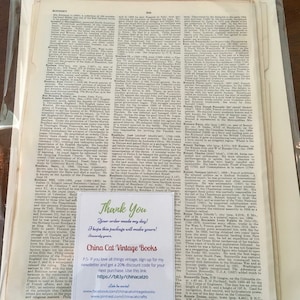 May include: A vintage book with a yellowed page showing a text about Boniface, a historical figure. The text is in black and white and includes a thank you note with a website address for China Cat Vintage Books.