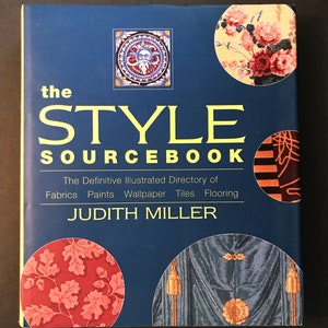 May include: The cover of a book titled "The Style Sourcebook: The Definitive Illustrated Directory of Fabrics, Paints, Wallpaper, Tiles, Flooring" by Judith Miller. The cover features a blue background with colorful illustrations of various patterns and designs.