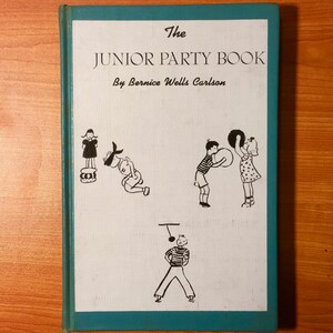 May include: The cover of a vintage book titled "The Junior Party Book" by Bernice Wells Carlson. The cover features a teal background with white text and illustrations of children playing games.