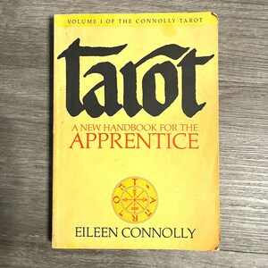 May include: A vintage book titled "Tarot: A New Handbook for the Apprentice" by Eileen Connolly. The cover is yellow with black and red text, and a circular emblem. The book is Volume 1 of The Connolly Tarot.