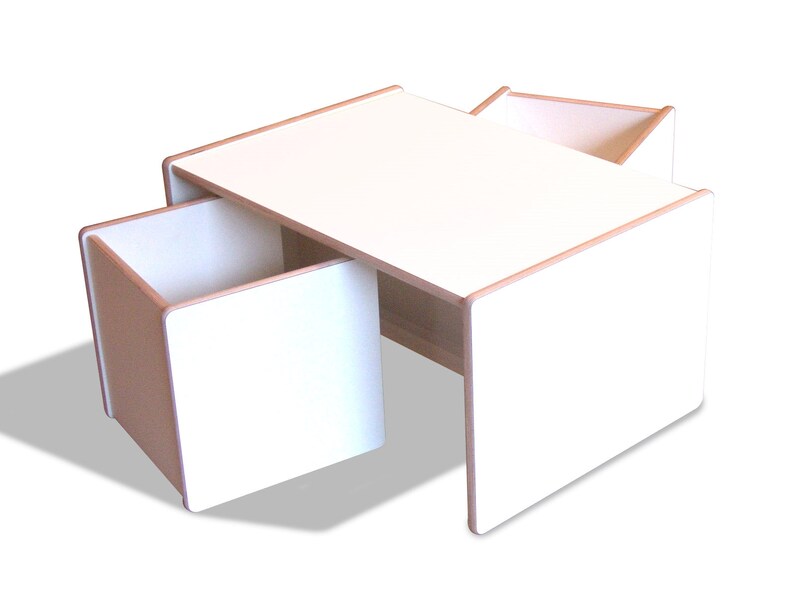 May include: White wooden table with two attached storage boxes. The table has a light wood trim around the edges.