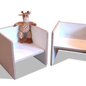 May include: Two white wooden chairs with a stuffed giraffe toy sitting on one of the chairs.