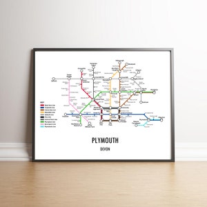 May include: A stylised map of the Plymouth, Devon, UK transit system. The map shows the different lines and stations, including the West Hoe Line, University Line, and Plymouth Line. The map is in a black frame.