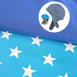 May include: A blue fabric layer sits atop a bright blue fabric featuring a white star pattern. A circular inset shows a blue and black striped hat with ear flaps and snap closures, alongside a blue helmet worn by a child with yellow straps.