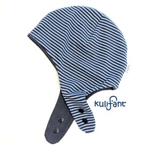May include: A light blue and dark blue striped hat with ear flaps, featuring black snap buttons on the flaps and the text kulifant printed in dark blue. The hat has a rounded crown and a small white brand tag on the side seam.
