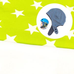 May include: A lime green fabric featuring a white star pattern, accompanied by a circular inset showing a blue and white striped hat with ear flaps and snap closures, alongside a blue helmet worn by a person with a yellow chin strap.