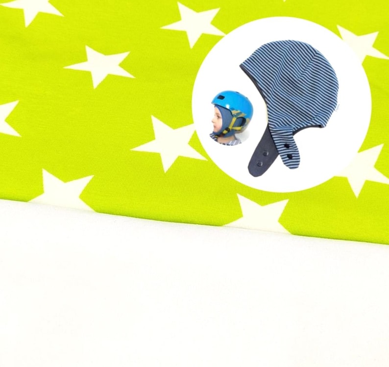 May include: A lime green fabric featuring a white star pattern, accompanied by a circular inset showing a blue and white striped hat with ear flaps and snap closures, alongside a blue helmet worn by a person with a yellow chin strap.
