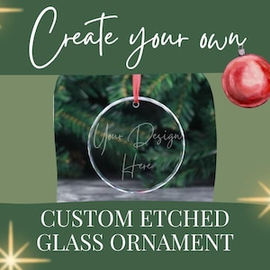 May include: A clear, round glass ornament with the text "Your Design Here" etched on it, hanging from a red ribbon. The image also includes a red Christmas ornament and the text "Create your own" and "CUSTOM ETCHED GLASS ORNAMENT".