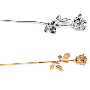 May include: Two silver and gold rose stems with crystal accents. The roses are arranged on a white background.