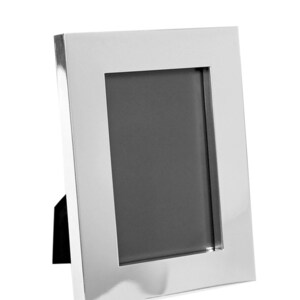 May include: A silver picture frame with a black stand. The frame has a wide border and a rectangular opening for a photo.