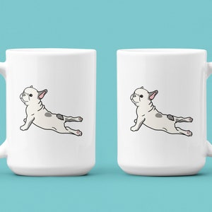 May include: Two white ceramic mugs with a black outline of a French bulldog doing a yoga pose on each mug.