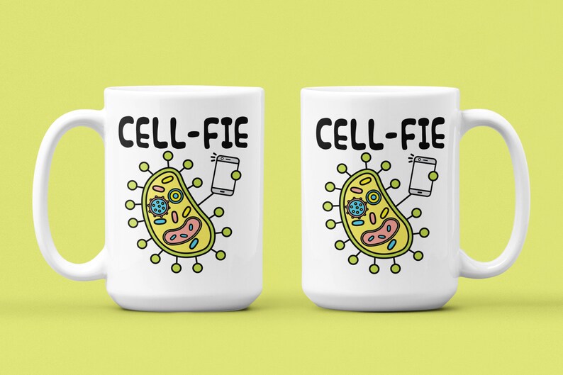 May include: Two white ceramic mugs with a black outline of a cell phone taking a selfie with a cartoon cell. The text "CELL-FIE" is printed in black on each mug.
