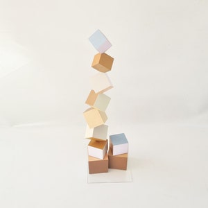 Wood sculpture in neutral colors, hand painted cubes each side in a different color. Decorative art sculpture, geometric design, modern deco