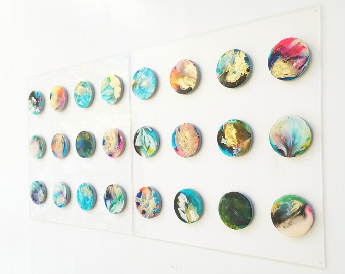 Wood art circles with resin finish on the top face. The circles are fixed on transparent acrylic glass. Large 3d art in bold colors.