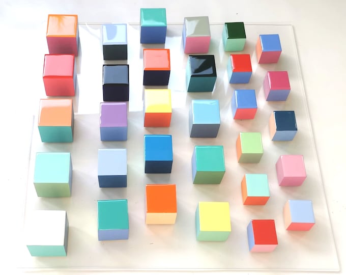 Wood wall art, modern 3d artwork. Sculpture wall art with resin finish on top face. Happy and colorful wood cubes. Acrylic glass base. ©
