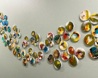 3d installation, hand painted circles with resin on top face. Each circle is a unique work of art. Glossy and shiny ©