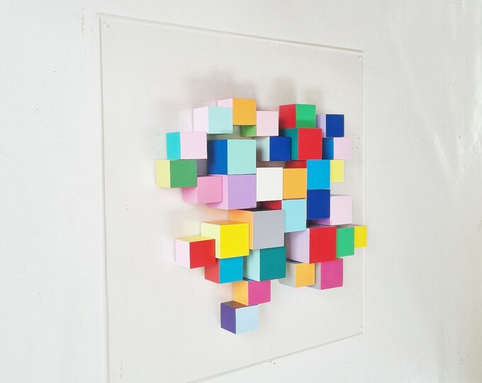 Hand-painted wooden cubes in bright and fun colors. Mounted on acrylic panel. Add color and originality to your space. Ready to hang. ©