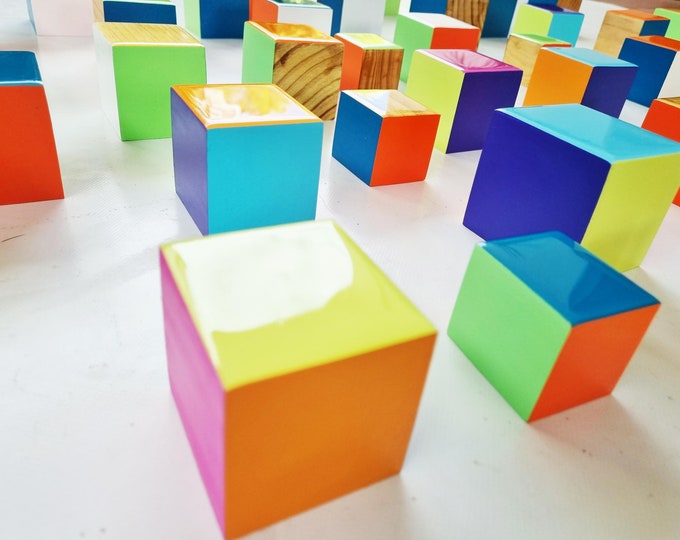 3d installation, Colored cubes with resin finish on top. Set of colorful blocks with some sides in natural wood. Modern sculpture 3d.
