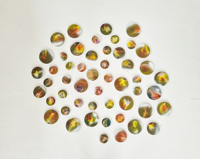3d installation, hand painted circles with resin on top face. Each circle is a unique work of art. Glossy and shiny ©