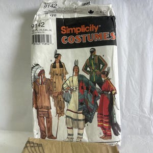 May include: A Simplicity 9142 sewing pattern envelope for costumes featuring illustrations of five different outfits labeled A, B, C, D, and E. The white paper envelope displays the text Simplicity COSTUMES and includes a barcode and size range XS, S, M, L, XL.
