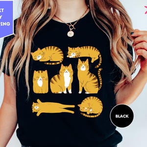 a woman wearing a t - shirt with cats on it