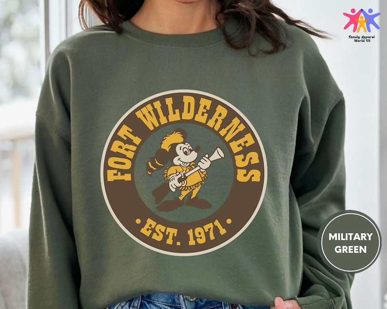 a woman wearing a sweatshirt with a cartoon of a man holding a baseball bat