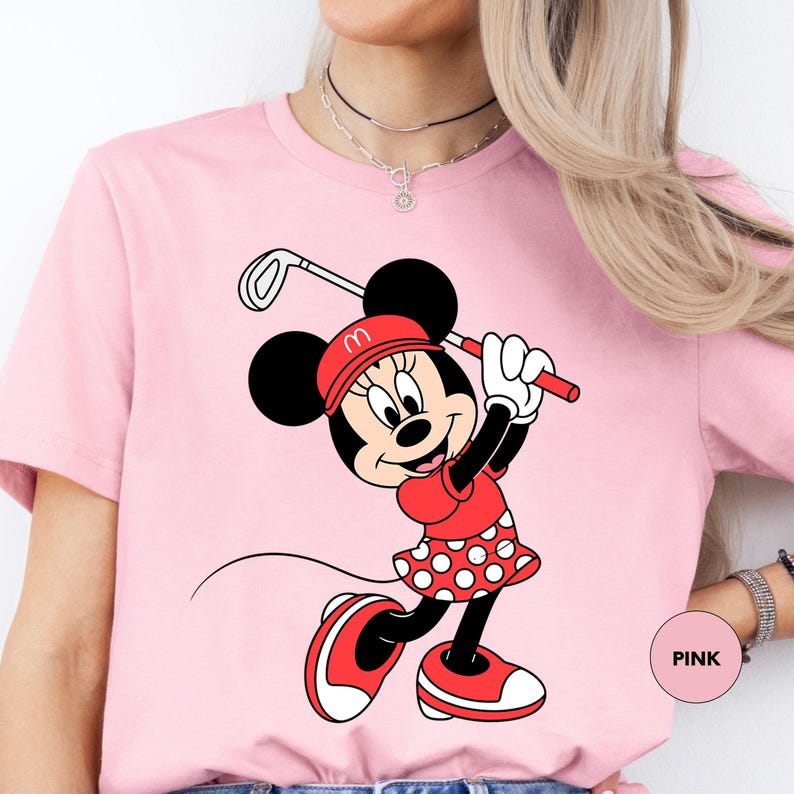 a woman wearing a pink minnie mouse t - shirt