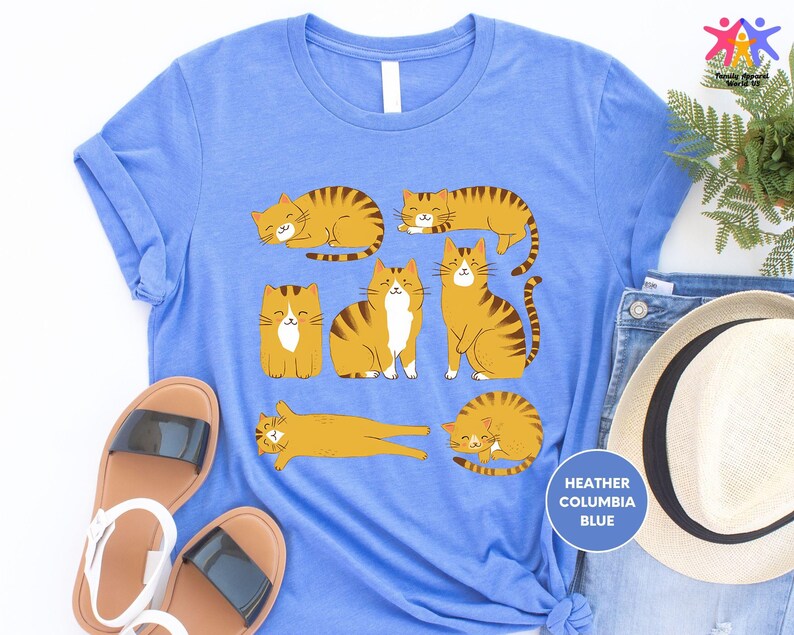 a blue t - shirt with three cats on it