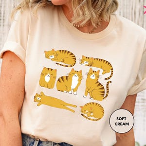 a woman wearing a t - shirt with cats on it