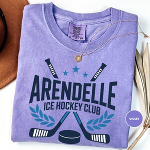 a t - shirt with a picture of an ice hockey club on it