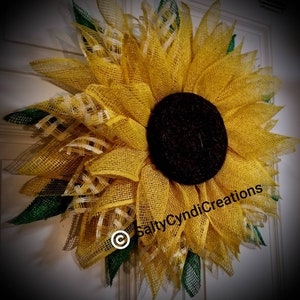 A traditional Spring, Summer or Fall wreath. Custom made with multicolored Yellows and creams.  Weather resistant burlap.