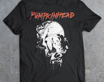 May include: Black t-shirt with a white graphic of a creature with a pumpkin head, a tree, and a full moon. The text "PUMPKINHEAD" is printed in red above the graphic.