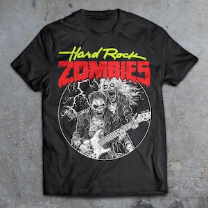 May include: Black t-shirt with a graphic of two zombie musicians playing a guitar. The text "Hard Rock Zombies" is printed in red and yellow on the shirt.