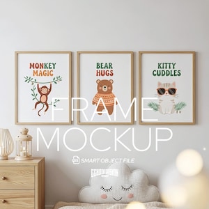 May include: Three framed art prints with whimsical animal illustrations. The prints feature a monkey, a bear, and a cat, each with playful text: "Monkey Magic," "Bear Hugs," and "Kitty Cuddles." The frames are light brown.