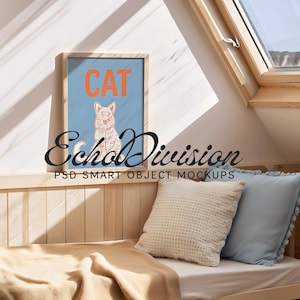 May include: A framed print with a light blue background and the word "CAT" in orange letters. A cartoon cat is sitting on the print. The print is hanging on a wall in a room with a wooden bed and pillows.