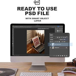 May include: A computer monitor displays a PSD file with a smart object layer. The screen shows a poster with the words "SOUR LOVE" on a chair. A keyboard, mouse, and other items are on a wooden desk.